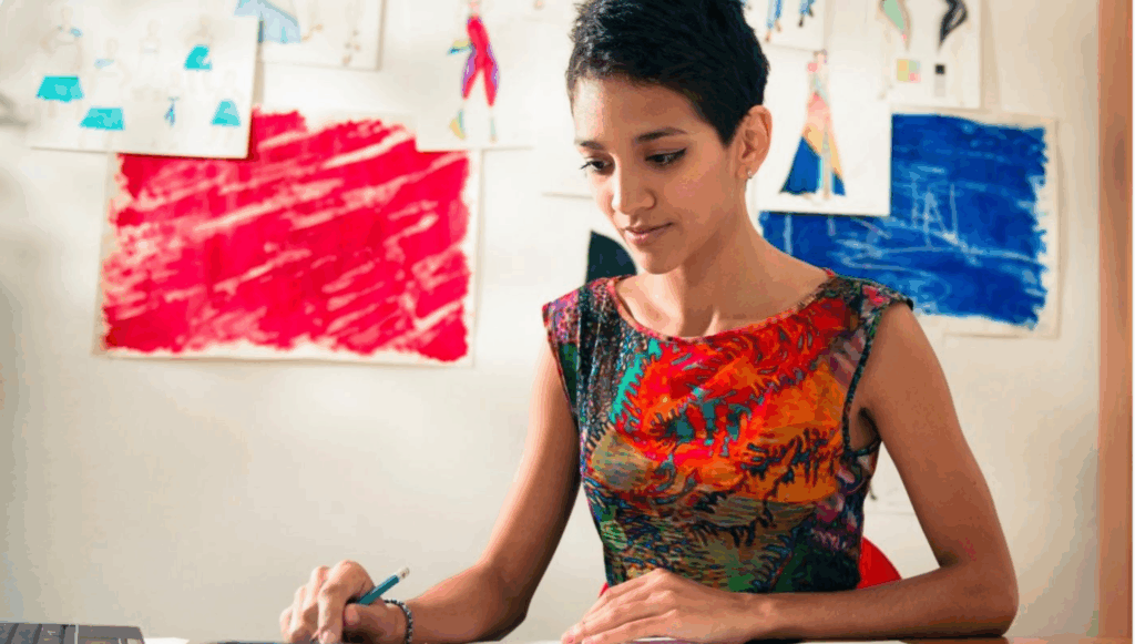 Woman sat a desk with a pen in her hand