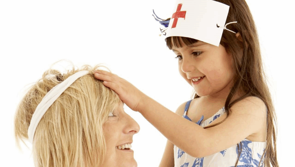 Little girl dressed as a nurse pretending to take the temperature of an adult