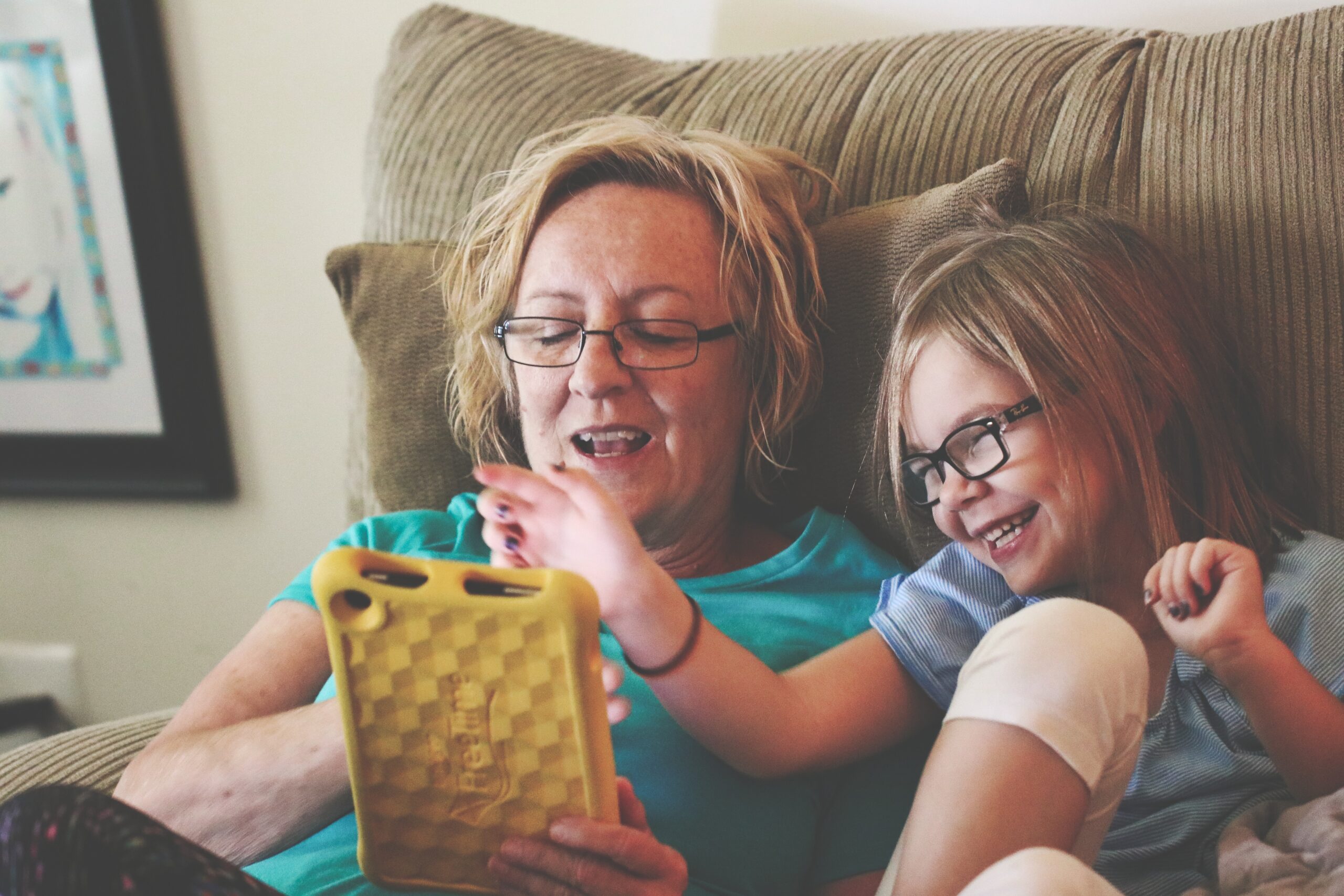Child and adult using tablet