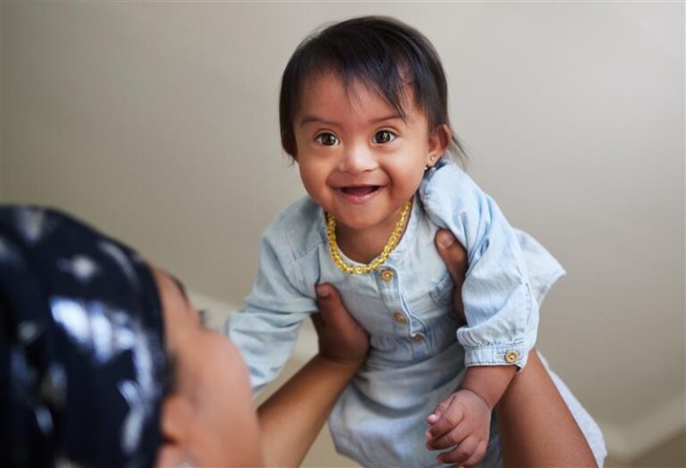 Little girl being lifted into the air smiling