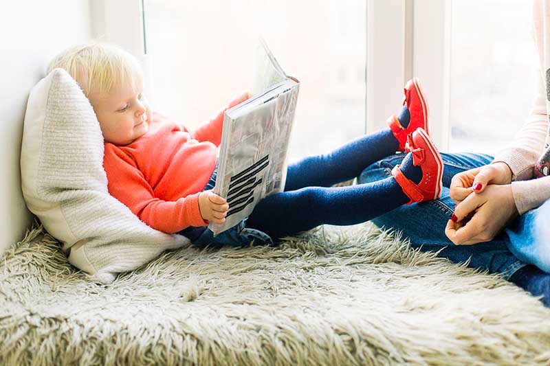 baby reading book corner