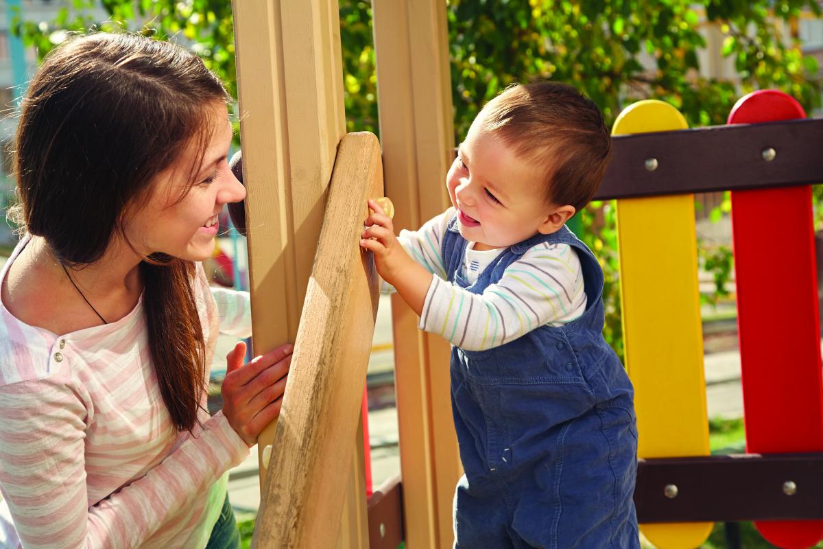 a woman and toddler gaze at each other, smiling