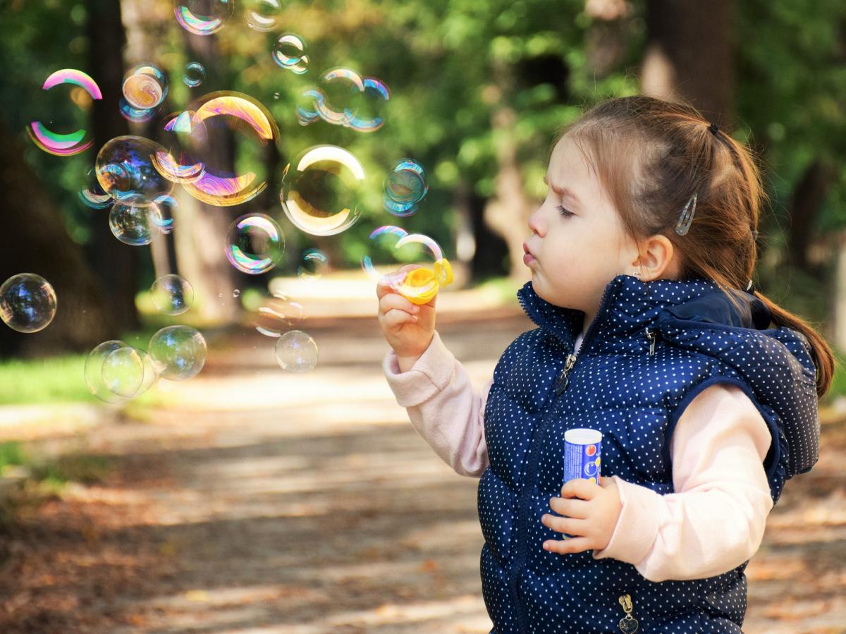 boy enjoys blowing bubbles