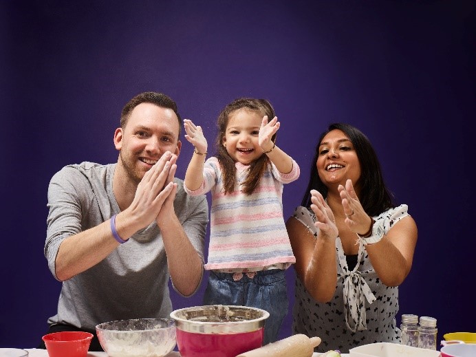 Maia, having fun baking with Mum and Dad