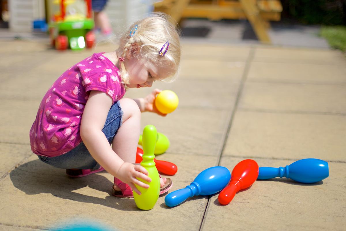 girl playing with skittles