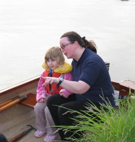 Julie and a young girl enjoying the river