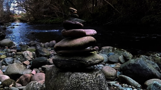 Stones stacked by a river