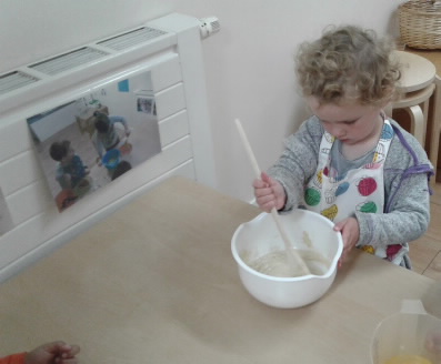 A young girl takes part in cake making