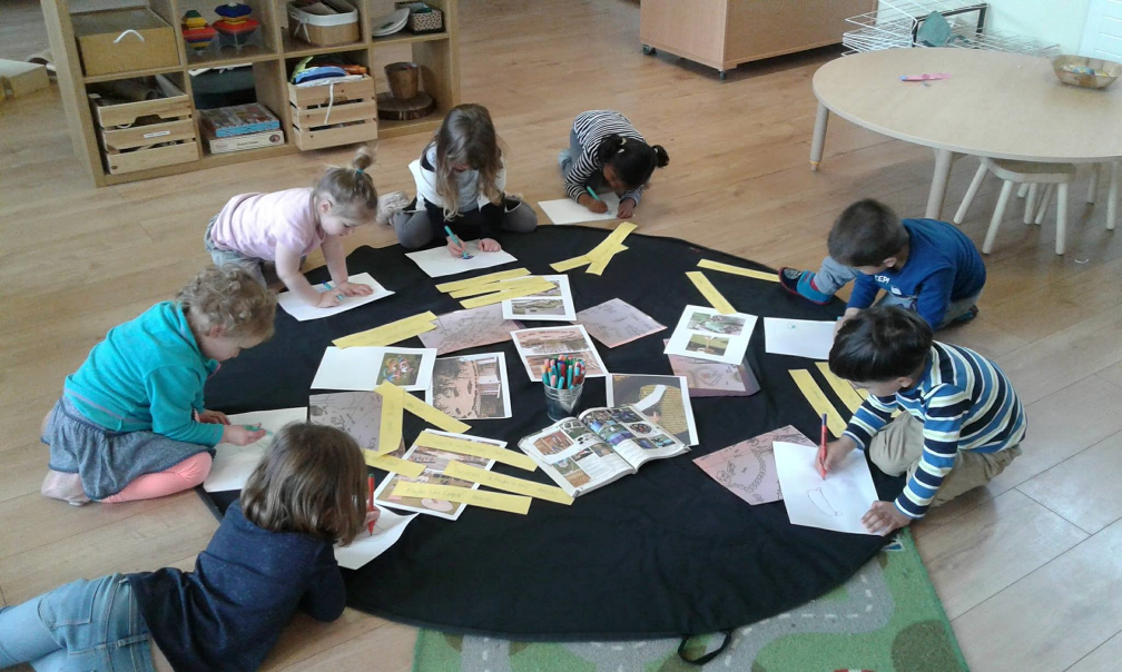 Children, aged 3-5, designing a play-scape whilst engaged in discussion 