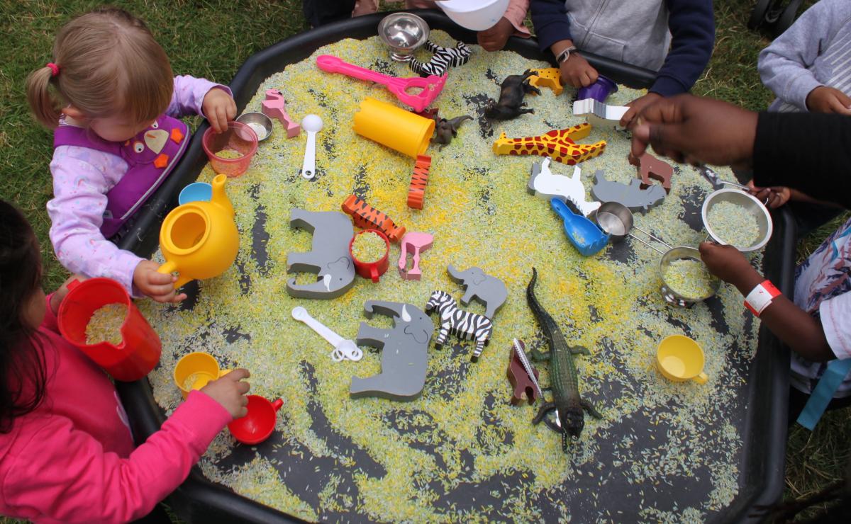 children playing with rice tray