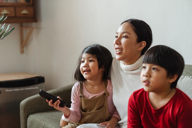 children watching TV with parent