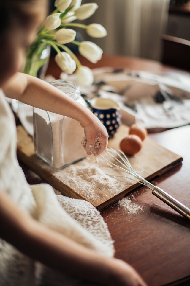 girl sifting flour