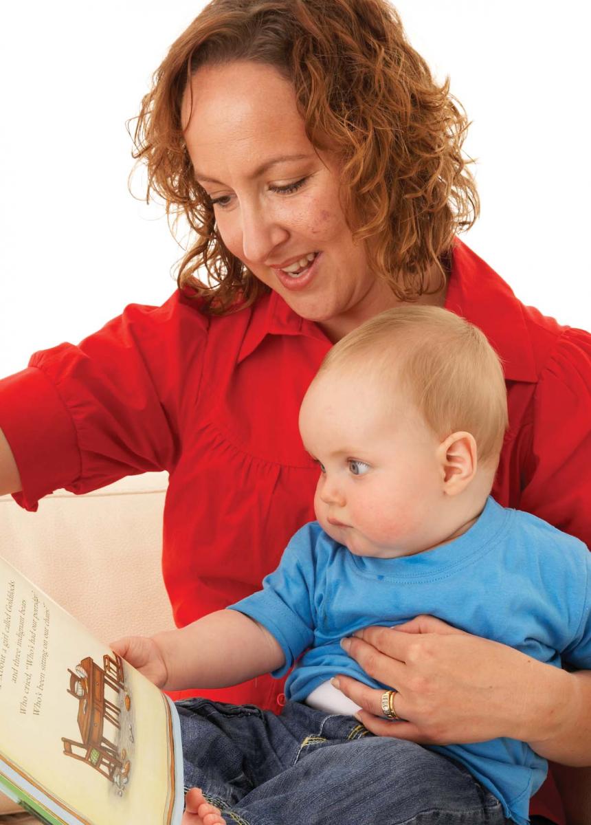woman reads to baby