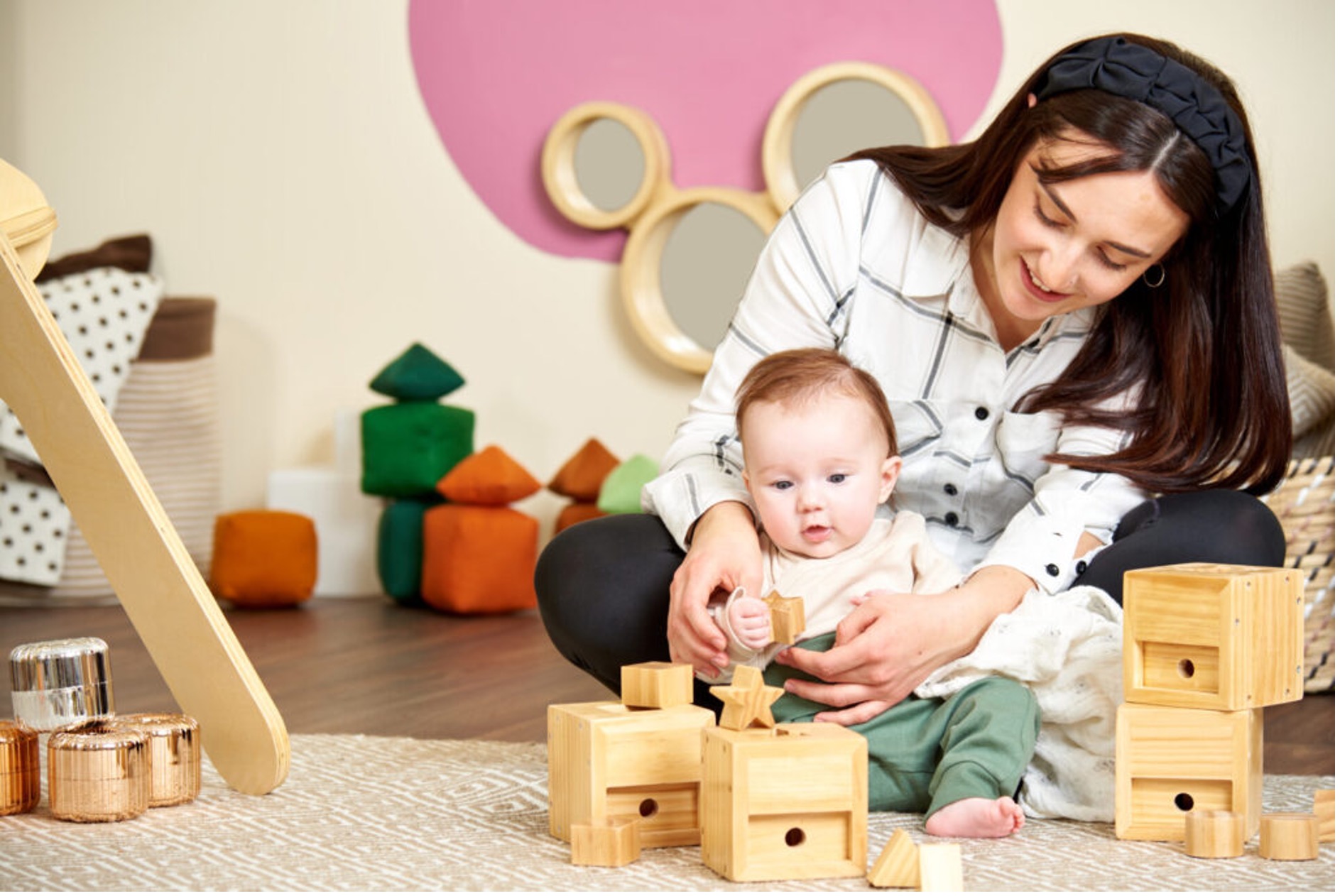 mother and baby play with wooden bricks