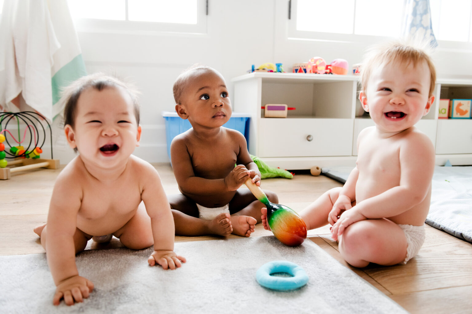 Babies playing together in a play room