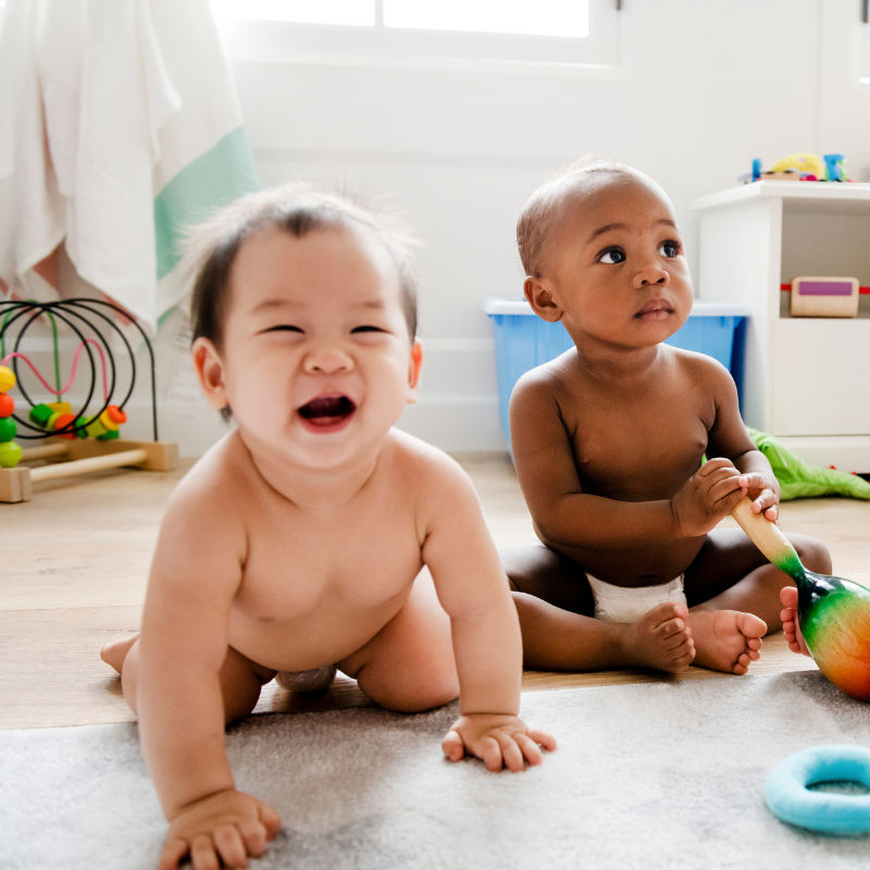 Babies playing together in a play room