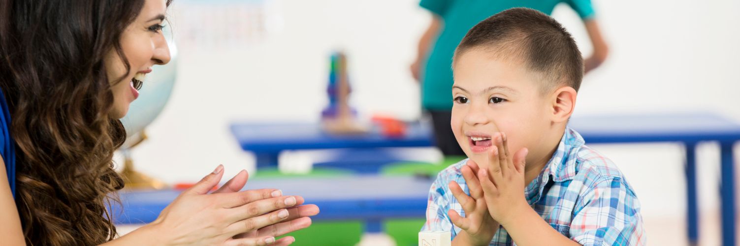Little boy playing with educator